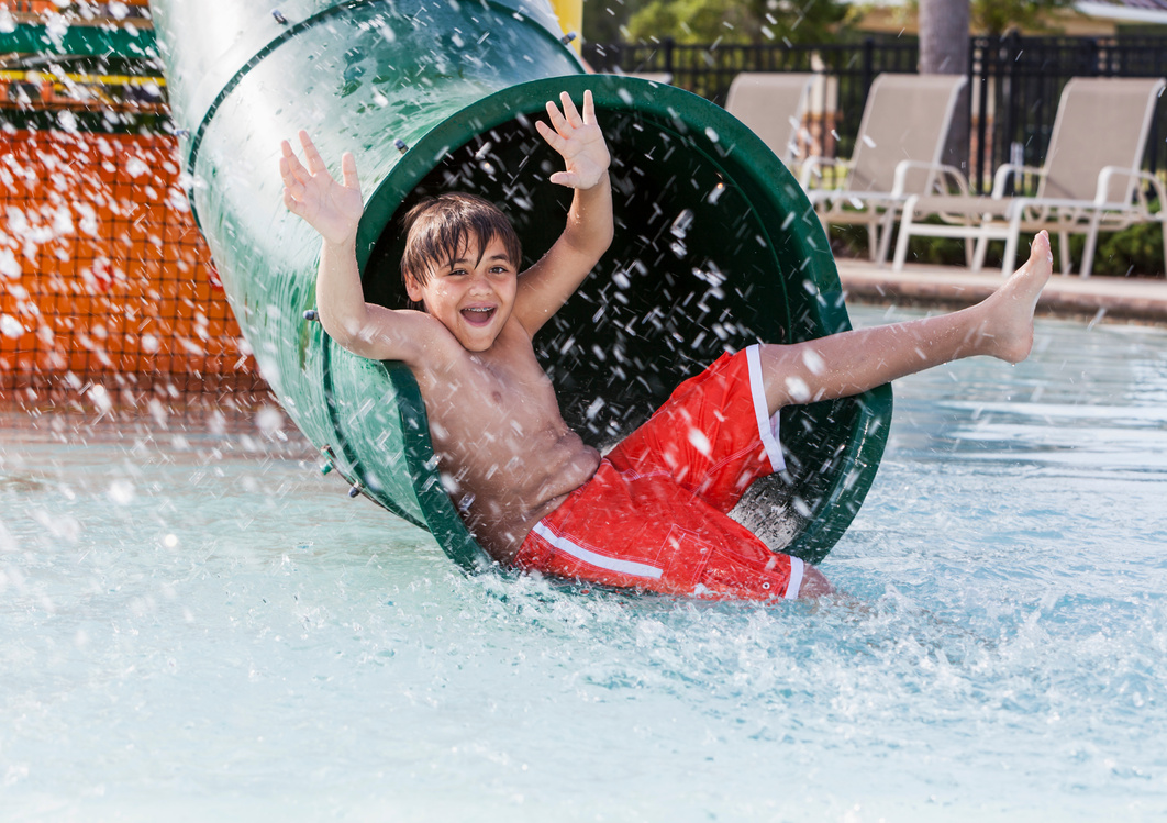 Boy playing on water slide